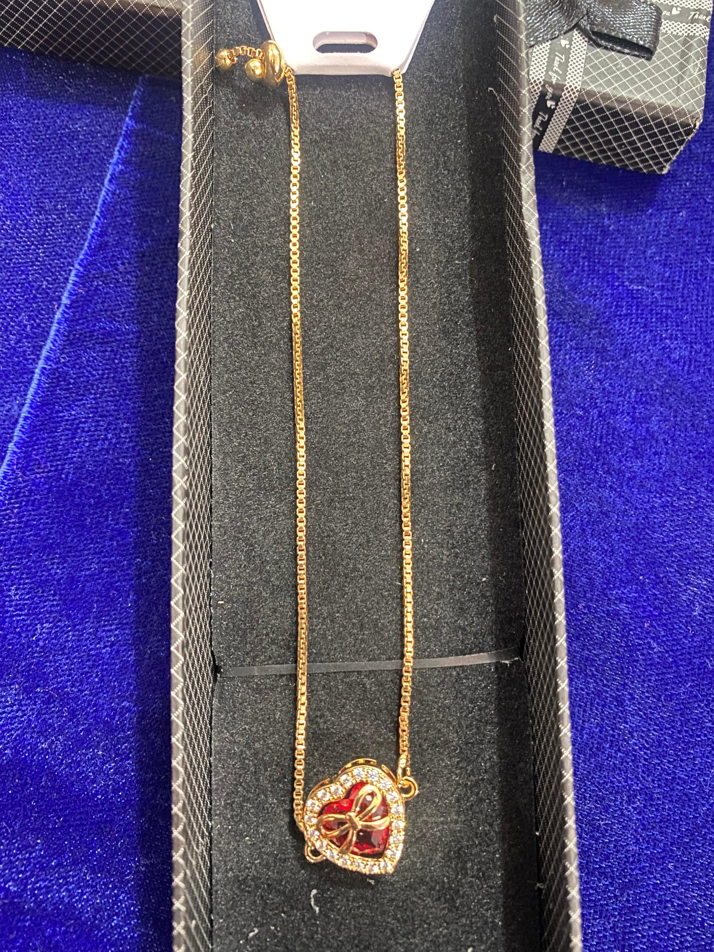 Gold necklace with a heart-shaped stone pendant