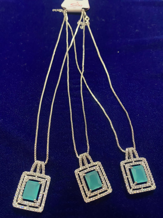 Set of Three square-shaped pendants with teal centers on a silver chain