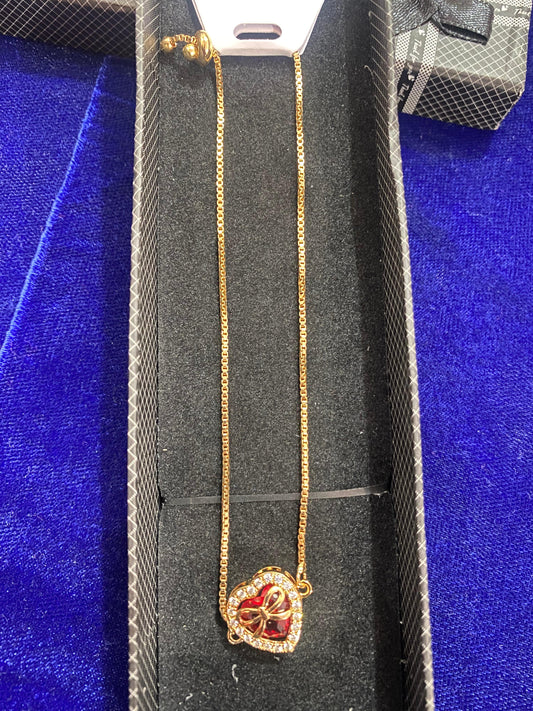 Gold necklace with a heart-shaped  stone pendant