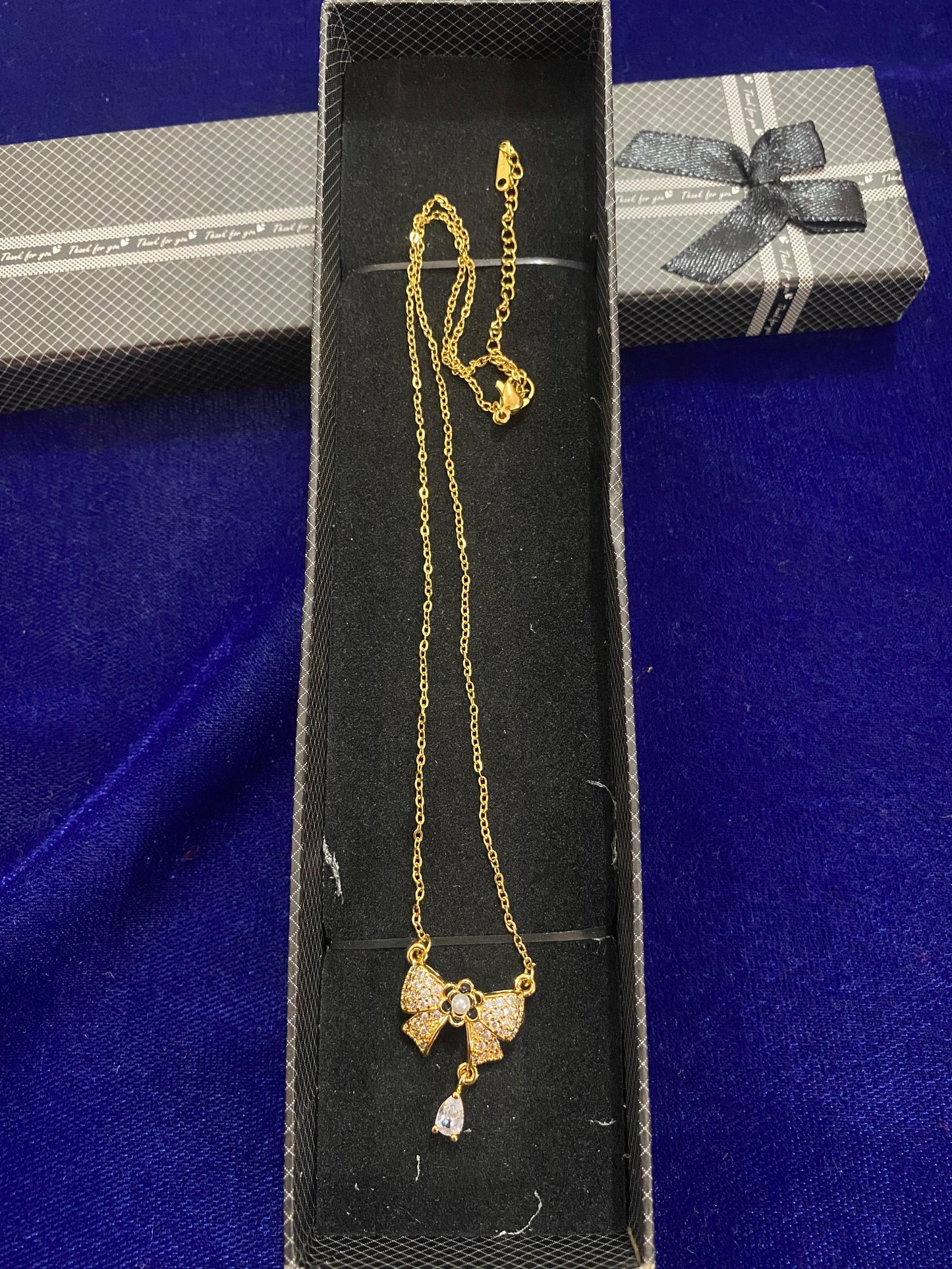 Gold chain with a bow pendant