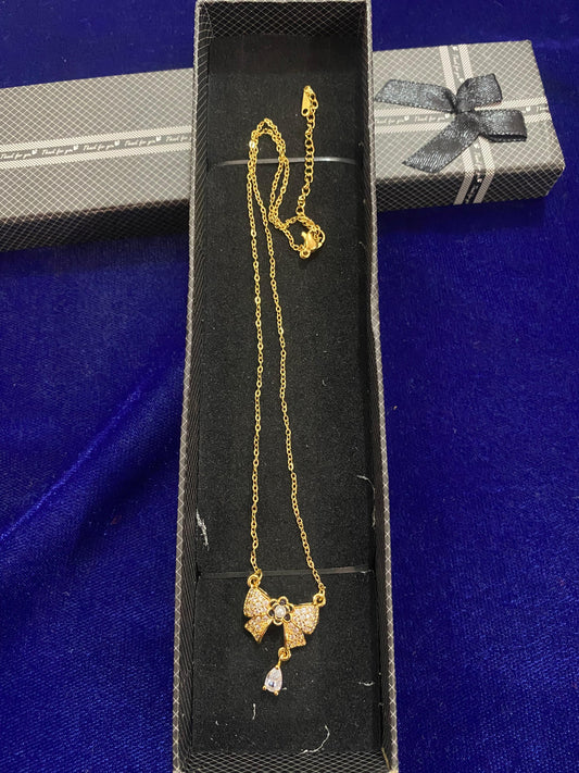 Gold chain with a bow pendant