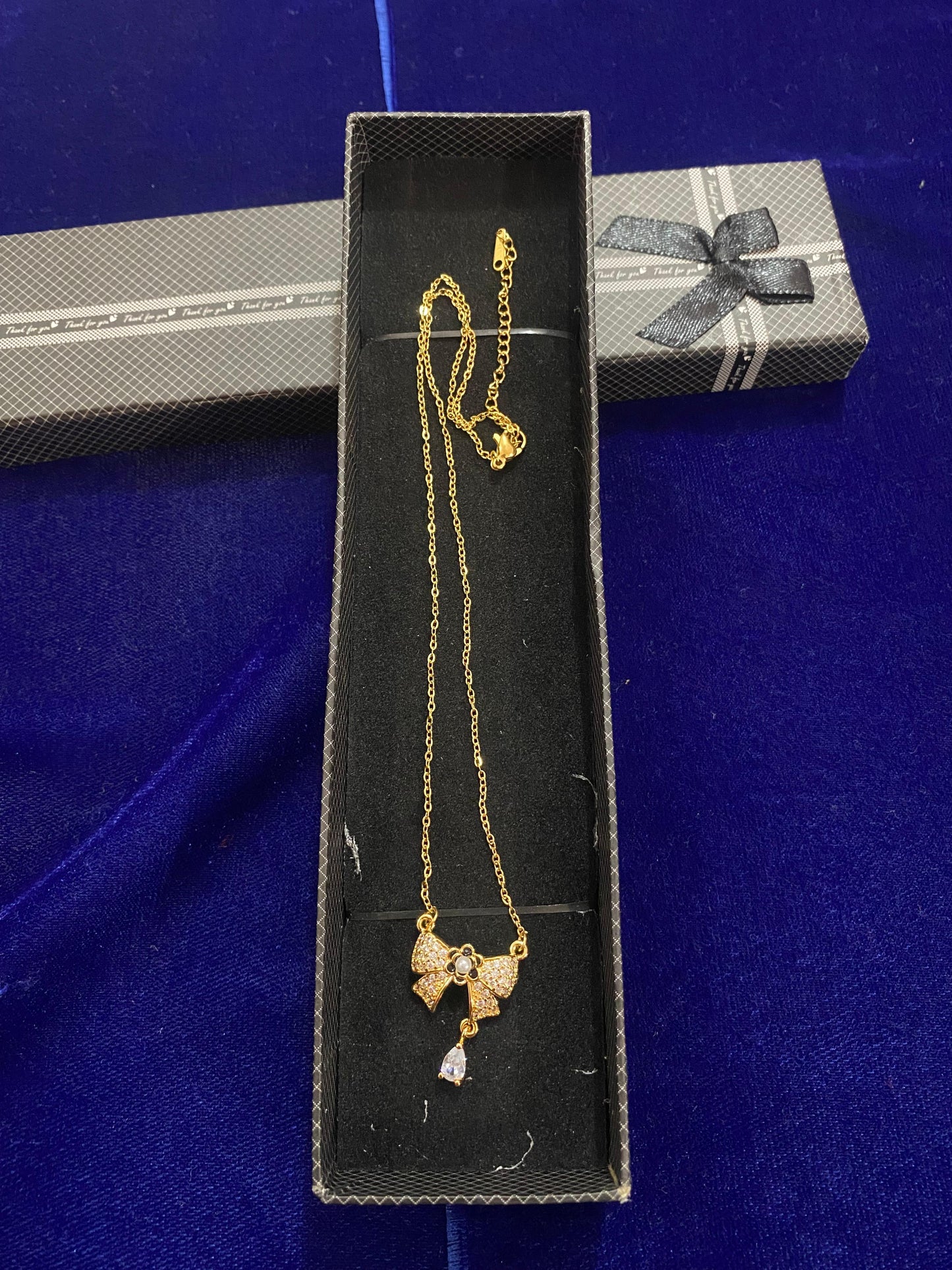 Gold chain with a bow pendant